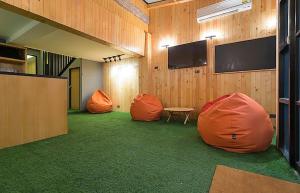 a room with two orange bean bags and a table at Double Five in Bangkok +17 photos
