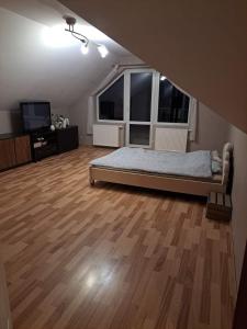 a bedroom with a bed and a large window at Agroturystyka Biełka in Giełczyn +11 photos