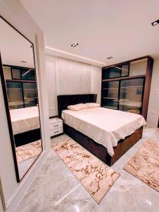 a bedroom with a large bed and a large mirror at Luxury Furnished Condo in Egypt in Cairo