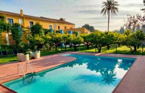 a swimming pool in front of a house at MAS DE BERNIS - Masia in L'Aldea