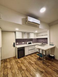 an empty kitchen with a table in a room at Rajhans Belliza By Honest Homes in Surat