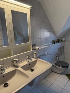 a bathroom with a sink and a toilet at Schickes Apartment am Rhein in Koblenz +17 photos