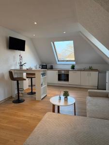 a living room with a couch and a table at Schickes Apartment am Rhein in Koblenz