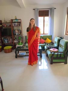 a woman is standing in a living room at Oasis Suite in Kandy