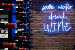 a sign that says save water drink wine at Hotel Restaurant Silberberg in Wolfsberg +3 photos