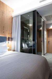 a bedroom with a bed and a bathroom at Hotel Restaurant Silberberg in Wolfsberg