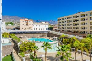 een uitzicht op een resort met een zwembad en palmbomen bij Ocean Garden FL FREE WIFI in Playa Paraiso