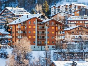 a building with snow on top of it at Apartment Les Chouettes 4 by Interhome in Nendaz