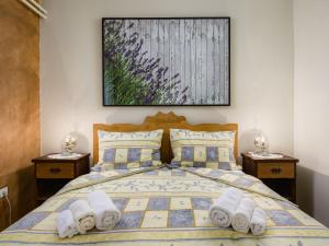 a bedroom with a bed with towels on it at Apartment Pina by Interhome in Tinjan