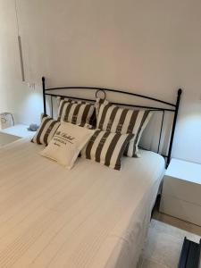 a bedroom with a bed with two pillows on it at Casa Isabell Con Piscina Privata in San Teodoro +24 photos