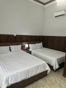Postel nebo postele na pokoji v ubytování Nam Anh Hotel