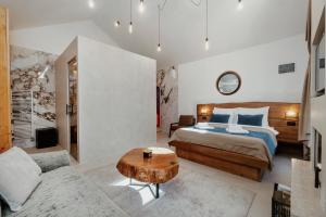 a bedroom with a bed and a coffee table at Toplik Village Resort in Lukavica