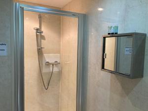 a shower with a glass door in a bathroom at The Buck Inn in Whitby +23 photos