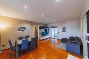 a dining room and living room with a table and chairs at Wow Waterfront Apartment in Bari