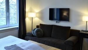 Sjónvarps- og/eða afþreyingartæki á Home Hotel Norre Park