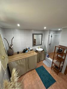 a bathroom with a sink and a mirror at Casa Cachalote - Ferienhaus auf den Azoren in São Caetano