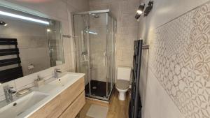 a bathroom with a shower and a sink and a toilet at Les Vues de Lily - Châtel in Châtel
