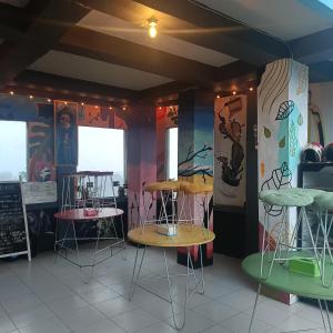 a store with two tables and chairs in a room at Kristian Homestay in Bajawa +119 photos