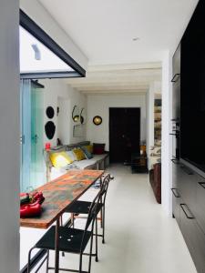 a dining room and living room with a table and chairs at Unique Townhouse with rooftop pool in Estepona