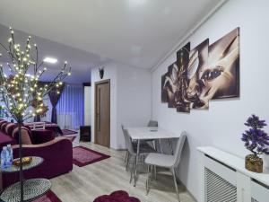 a living room with a couch and a table at Purple Suite in Sinaia +14 photos