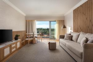 a living room with a couch and a table at Grande Real Santa Eulalia Resort & Hotel Spa in Albufeira