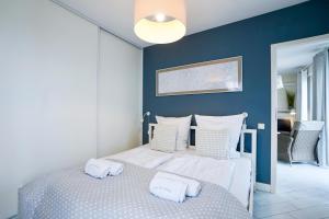 a bedroom with a bed with two towels on it at Horyzont by Baltic Home in Międzyzdroje +71 photos