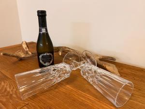 a bottle of wine and a glass bow on a table at Haus Lena Apartment 1 in Leopoldshagen