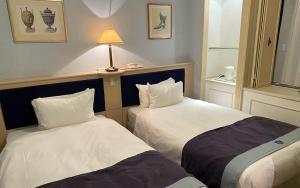 Postel nebo postele na pokoji v ubytování Hotel Monterey Osaka