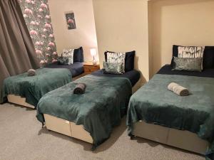 Ένα ή περισσότερα κρεβάτια σε δωμάτιο στο Cozy Accrington Retreat