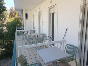 a row of tables and chairs on a balcony at Playa-degli-Angeli-PONENTE in Gabicce Mare