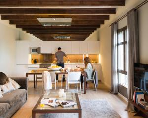 a man and a woman in a living room at Enjoybcn Miro Apartments in Barcelona