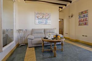 a living room with a couch and a table at Palacio de la Canaliega in El Rocío +45 photos