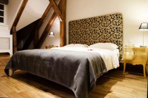 a bedroom with a large bed with a large headboard at Dolce Vita Suites Boutique in Prague