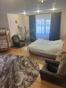 a living room with two beds and a couch at Fetal Hut - Плідна Хата in Verkhovyna +53 photos