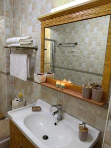 a bathroom with a sink and a mirror at 4Br Beautiful Mansion Mombasa rd in Nairobi +10 photos