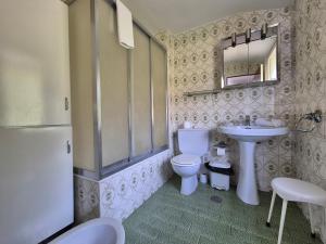 a bathroom with a sink and a toilet and a mirror at 14A05 Apartamento con vistas in Lastres +18 photos