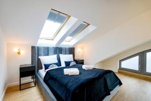 a bedroom with a bed with two towels on it at Marea by Baltic Home in Międzyzdroje