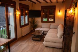 a living room with a couch and a table at ElSueñodeCelia 2 in Riosa