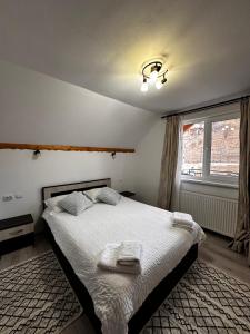 a bedroom with a bed with towels on it at Dor de munte in Măgura +22 photos