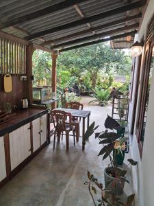 a kitchen and dining room with a table and chairs at Sulo House in Weligama