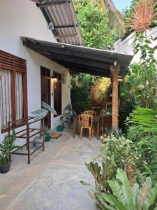 a patio of a house with a table and chairs at Sulo House in Weligama