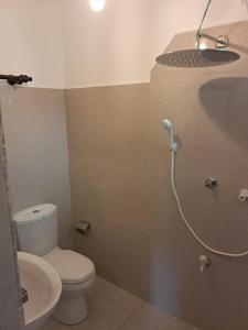a bathroom with a shower with a toilet and a sink at Sulo House in Weligama +26 photos