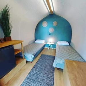 a room with two beds and a table at Pyhäranta Camping & Kievari in Pyhäranta