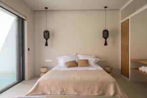 a bedroom with a bed with two pillows on it at GEA & HYDOR Private Residencies Antiparos in Agios Georgios