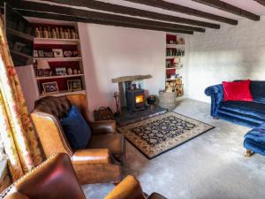 a living room with a couch and a wood stove at Rose Hip Cottage in Hexham