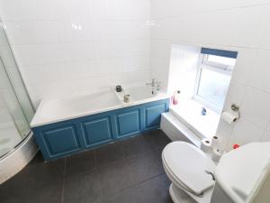 a bathroom with a tub and a toilet and a sink at Rose Hip Cottage in Hexham +33 photos