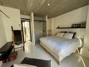 a bedroom with a large bed in a room at Unique Townhouse with rooftop pool in Estepona