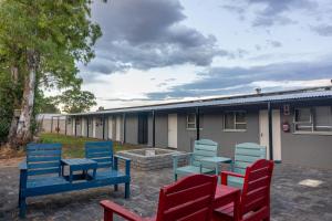 a group of chairs and tables in front of a building at Amberdale Estate Budget Self Catering in Queenstown