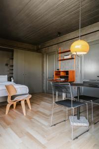 a bedroom with a bed and a table and chairs at SCALA by Valletta Vintage in Valletta