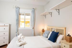 a bedroom with two beds and a window at Alma de Zahara in Zahara de los Atunes +21 photos